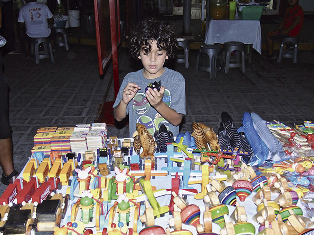 Adam Saleh, a visitor from
Houston, Texas, checks out the
toys.